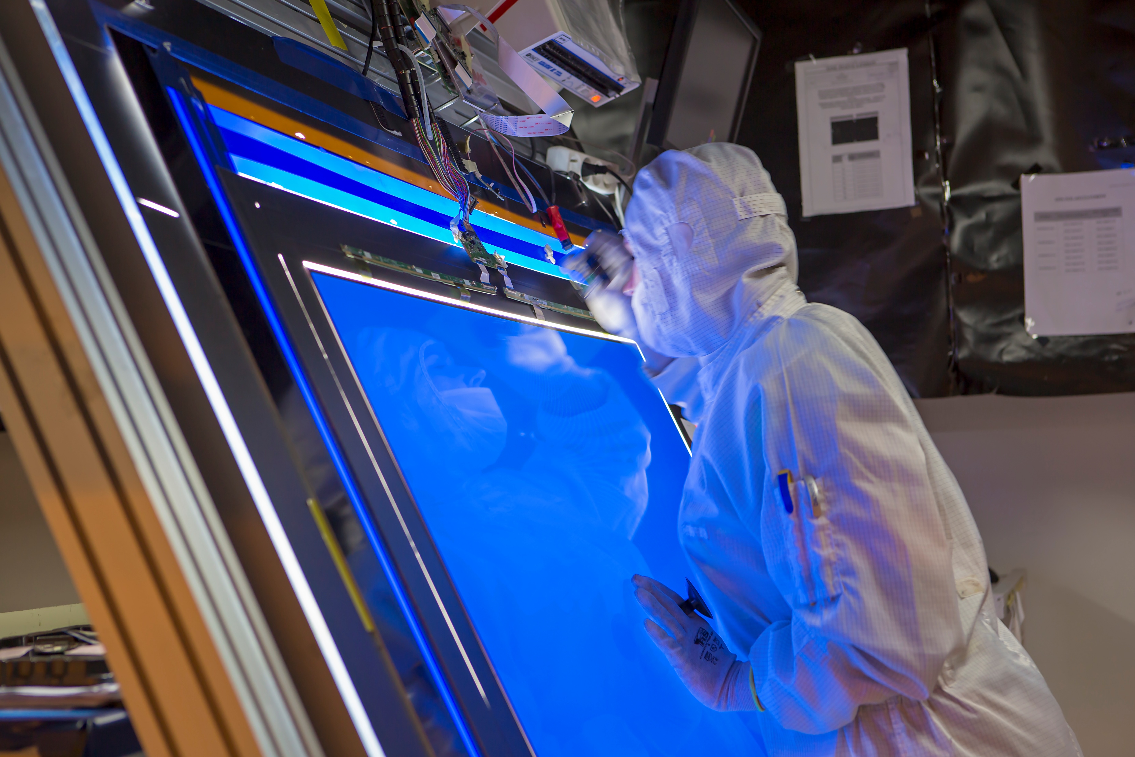 Engineer in cleanroom working on display technology